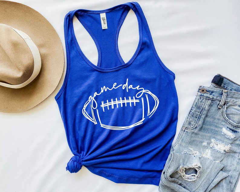 May include: A royal blue tank top with a white graphic of a football and the text "gameday".