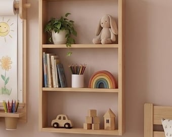 May include: A rectangular light wood wall shelf with three tiers. The top shelf holds a green potted plant and a plush rabbit. The middle shelf contains books, a white cup with colored pencils, and a rainbow arch. The bottom shelf features a wooden toy car, wooden blocks, and a wooden house.