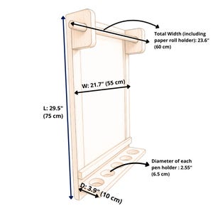 May include: A light-colored wooden wall-mounted paper roll holder and organizer with a shelf featuring five circular pen holders. Dimensions include a total width of 23.6 inches, a length of 29.5 inches, a width of 21.7 inches, a depth of 3.9 inches, and a 2.55-inch pen holder diameter.