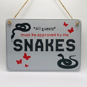All Guests Must Be Approved By the Snakes sign