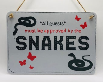 All Guests Must Be Approved By the Snakes sign