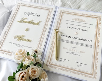 May include: A white and gold wedding certificate with an ornate border. The certificate states "This agreement is to certify the marriage of Zaakirah Khan & Abraan Aziz Rahiman." The date is June 21st, 2024, corresponding to 15th Dhul-Hijjah 1445 AH.