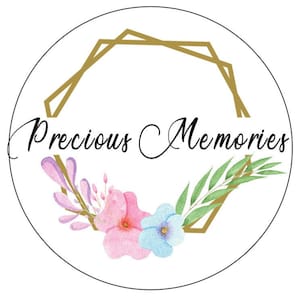 May include: A white circle with a gold geometric frame and the words "Precious Memories" in black cursive script. The frame is adorned with watercolor flowers in shades of pink, blue, and purple.