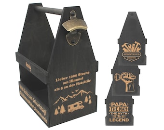 May include: A black wooden six-pack beer carrier with a built-in bottle opener. The carrier has a personalized message that reads "Lieber 1000 Sterne am Himmel als 5 an der Hoteltür".