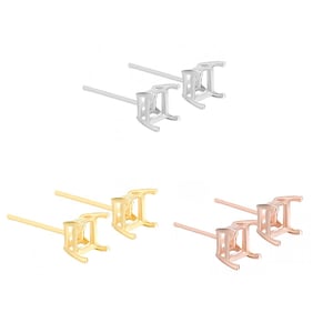 May include: Three pairs of earring settings, each pair in a different metal finish: silver, gold, and rose gold. Each setting is a square shape with a prong setting for a gemstone.