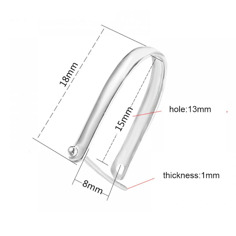 May include: Silver-toned metal hoop earring with a 1.5 inch diameter, 0.75 inch width, and a 0.39 inch hole. The earring is 0.04 inch thick.