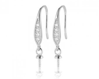 May include: Silver earring findings with a clear crystal design and a screw-on pearl setting.
