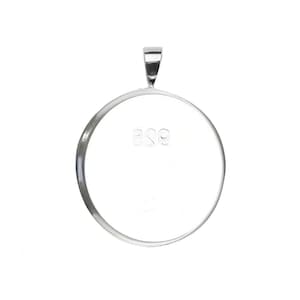 May include: A silver round pendant with a bail at the top. The back of the pendant is engraved with the number "925".