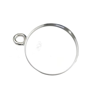 May include: A silver-coloured, round pendant setting with a loop for attaching to a chain or other jewellery component. The setting has a smooth, polished finish and a recessed area for an insert.