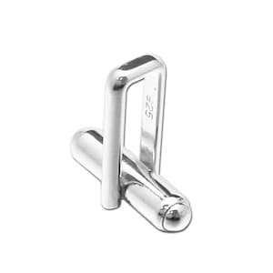 May include: Silver cufflinks with a square and a cylindrical shape. The square has a small opening and the cylinder has a rounded end. The cufflinks are marked with "925".
