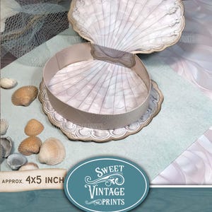 May include: A printable scallop box template, with a white and gold seashell design. The box is approximately 4x5 inches.