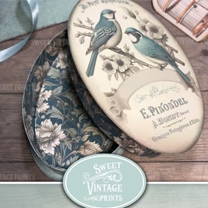 Puede incluir: Caja ovalada imprimible con un dise&ntilde;o vintage que presenta dos p&aacute;jaros azules posados en una rama con flores blancas. La caja est&aacute; etiquetada con "Au Petit Jardin Grec" y "E. Pikondel A Bondy (Seine) Graines Potag&egrave;res d'Elite".