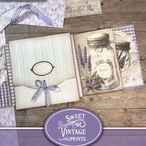 May include: A purple and white junk journal folio with a lavender theme. The folio features a vintage style design with a label that says "Lavender" and a decorative ribbon.