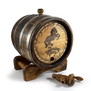 May include: A wooden barrel with a metal band and a tap. The barrel is decorated with a black and white image of a horse and the text "The Prancing Pony". The barrel is surrounded by the inscription "One Ring to rule them all, One Ring to find them, One Ring to bring them all, and in the darkness bind them".