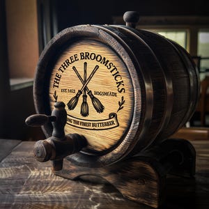 May include: A wooden barrel with the text "The Three Broomsticks" and crossed brooms. The barrel has a spigot and is mounted on a wooden stand. The text "Serving the Finest Butterbeer" is also visible.