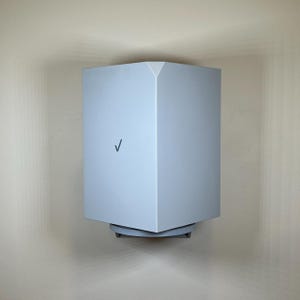 May include: A light blue, geometric-shaped device mounted on a wall. The device has a checkmark logo and a square base. The device is a modern design, with a clean, minimalist aesthetic.