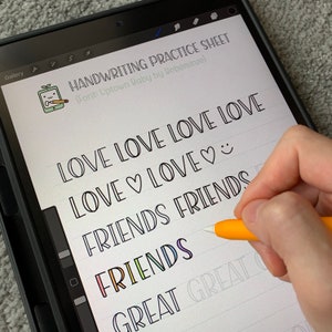 May include: A digital tablet screen displaying a handwriting practice sheet with the words "LOVE LOVE LOVE LOVE", "LOVE♡LOVE♡", "FRIENDS FRIENDS", "FRIENDS", and "GREAT GREAT" written in a cursive font. The words are written in black ink on a white background with lined paper.