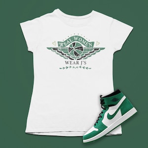 May include: White t-shirt with a green graphic of a basketball with wings and the text "Real Women Wear J's". A green and white high-top sneaker is also pictured.
