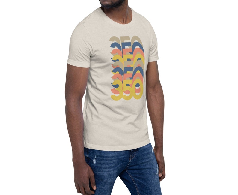 May include: A beige t-shirt with a graphic design of the number 360 in a retro style with overlapping layers of yellow, orange, pink, and blue.