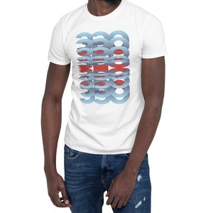 Puede incluir: Camiseta blanca con un dise&ntilde;o apilado de formas azules y rojas superpuestas. El gr&aacute;fico est&aacute; centrado en la parte delantera de la camiseta. La camiseta est&aacute; hecha de un material suave.