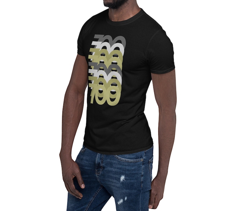 May include: A black short-sleeved t-shirt with a graphic design of the number 700 repeated in different shades of gray and gold.
