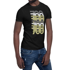 May include: A black t-shirt with a graphic design of the number 700 repeated in different shades of gray and gold.