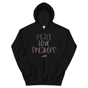May include: Black hooded sweatshirt with the text "Peace Love Sneakers" in brown and gray lettering.