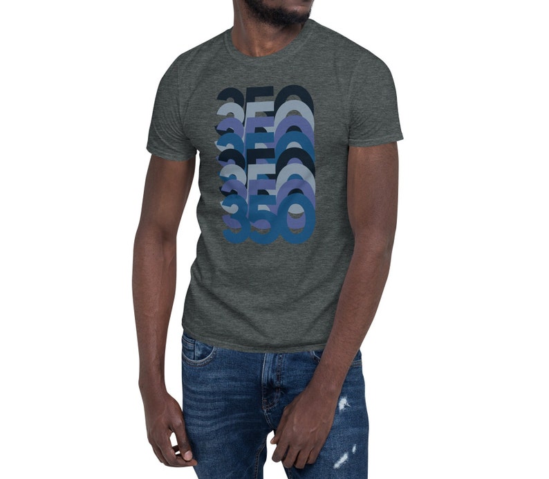 Peut inclure: Un t-shirt gris chin&eacute; fonc&eacute; avec un graphique r&eacute;tro du nombre 360 dans des tons bleus et violets.