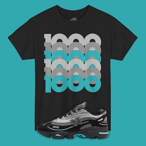 May include: Black t-shirt with a graphic design of the number "1000" in gray and teal. A black and gray athletic shoe with teal accents is positioned below the shirt.