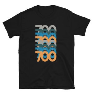 May include: Black t-shirt with a graphic design of the number 700 repeated in different colors and sizes.