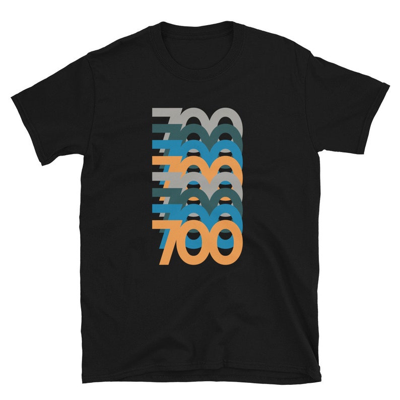 May include: Black t-shirt with a graphic design of the number 700 repeated in different colors and sizes.