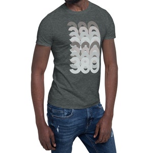 May include: A dark heather grey t-shirt with a graphic design of the number 360 repeated in a layered pattern. The numbers are in shades of grey.