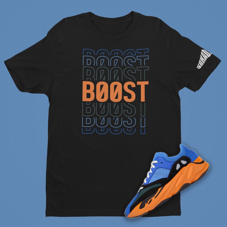 May include: Black t-shirt with the word "BOOST" repeated in a gradient of blue and orange. A blue and orange sneaker is shown below the shirt.