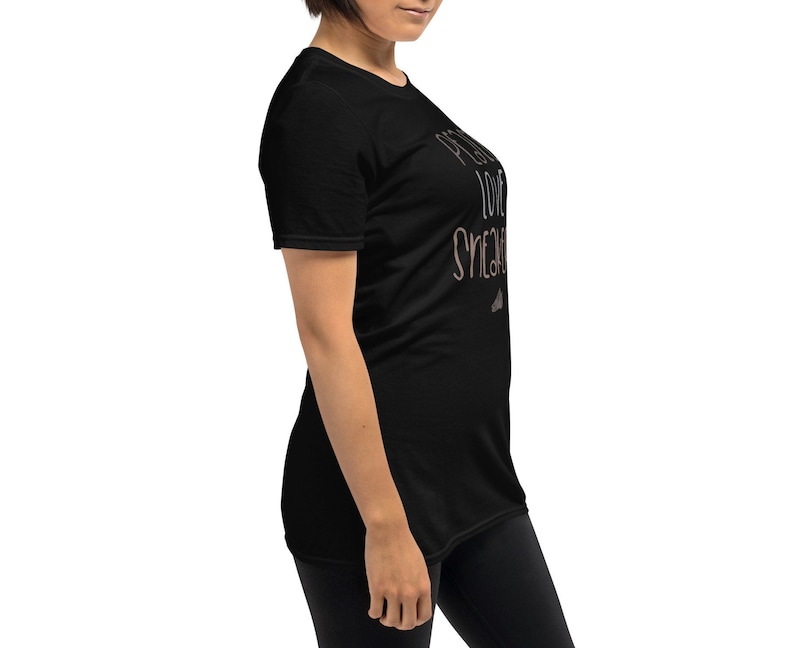 May include: Black short-sleeved t-shirt with the text "Pretty Love Sneakers" in a light brown color.