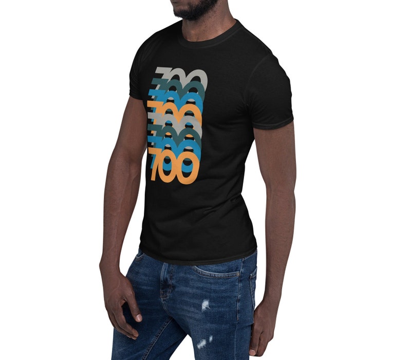 May include: A black t-shirt with a graphic design of the number 700 repeated in different colors, including orange, blue, and green.