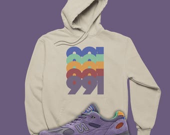 Sudadera con capucha apilada 991 a juego con la camiseta unisex NB 991v2 de Salehe Bembury.
