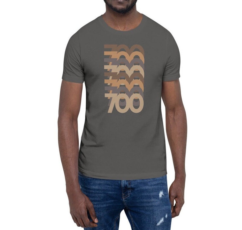 May include: A charcoal grey t-shirt with a retro-style graphic of the number 700 in brown, beige, and grey.