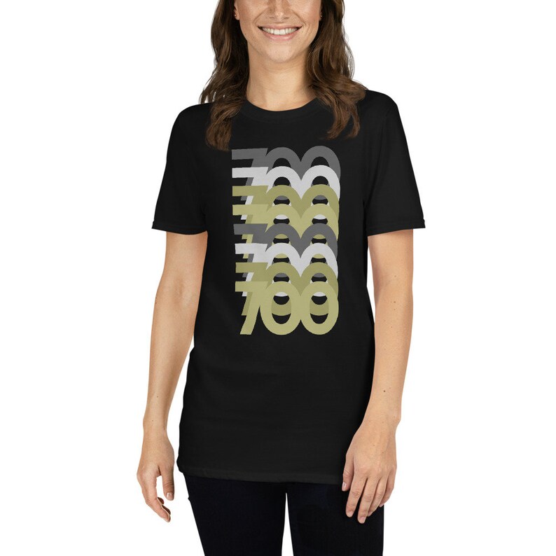 May include: A black t-shirt with a graphic design of the number 700 repeated in different shades of gray and green.