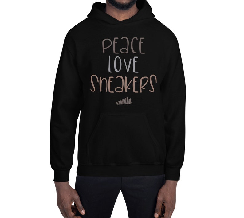 May include: Black hooded sweatshirt with the text "Peace Love Sneakers" in brown and white lettering.