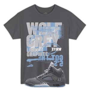 May include: A gray t-shirt with the words "WOLF GREY" and other text in white and light blue. A pair of gray and light blue sneakers with the number "23" are in the foreground.