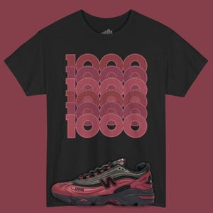 May include: Black t-shirt with a repeating "1000" design in shades of red. A red and black athletic shoe is displayed below the shirt. The shoe has a black sole and red accents.