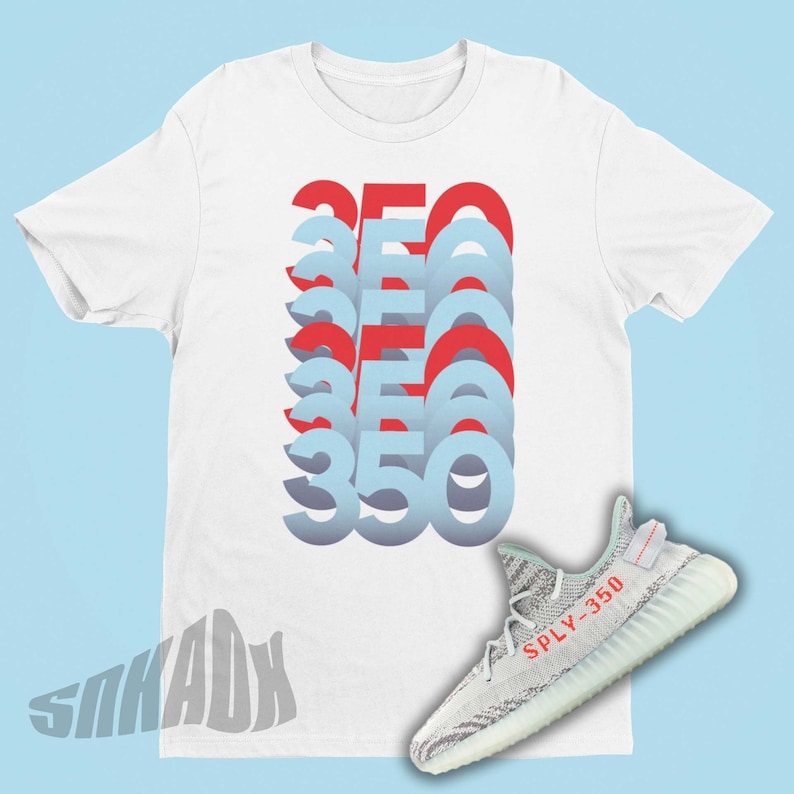May include: White t-shirt featuring a graphic of the number 350 repeated in red and blue. A pair of grey and white trainers with the text "SPLY-350" in red is shown below the t-shirt.