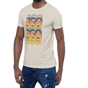 May include: A beige t-shirt with a retro-style graphic of the number 350 repeated in different colors, including yellow, orange, pink, and blue.