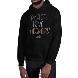 May include: Black hooded sweatshirt with the text "Peace Love Sneakers" in white and brown lettering.