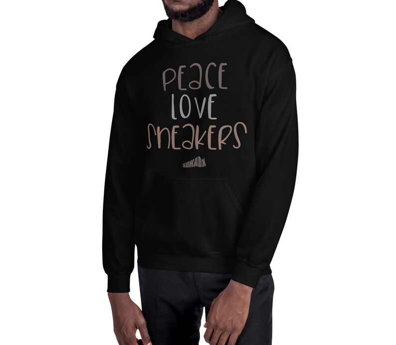May include: Black hooded sweatshirt with the text "Peace Love Sneakers" in white and brown lettering.