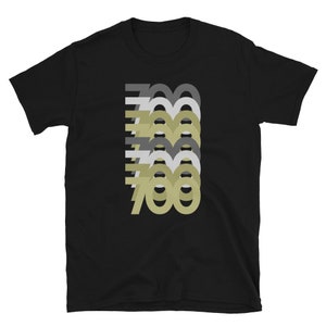 May include: Black t-shirt with a graphic design of the number 700 repeated in different shades of gray and beige.