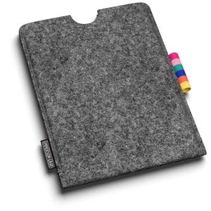 May include: A grey felt tablet sleeve with a colourful tab. The sleeve has a cutout at the top and a small tag with text on the bottom left. The felt material is a solid grey colour.