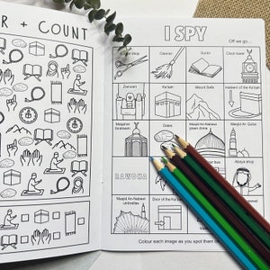 May include: A black and white illustrated children's book with an 'I Spy' game featuring Islamic symbols and landmarks. The book includes a list of items to find, such as a clock tower, a mosque, and a Ka'bah.