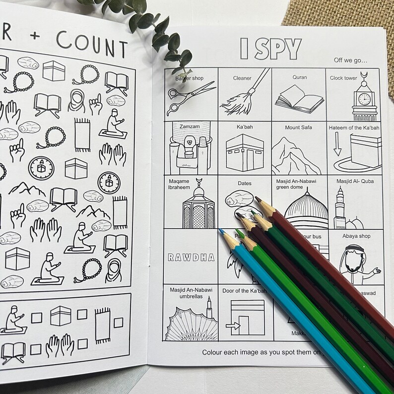 May include: A black and white illustrated children's book with an 'I Spy' game featuring Islamic symbols and landmarks. The book includes a list of items to find, such as a clock tower, a mosque, and a Ka'bah.