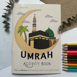 May include: A colouring book with a crescent moon and a mosque on the cover. The title is "Umrah Activity Book" and the text below says "Fun and effective way of teaching children how to perform Umrah".